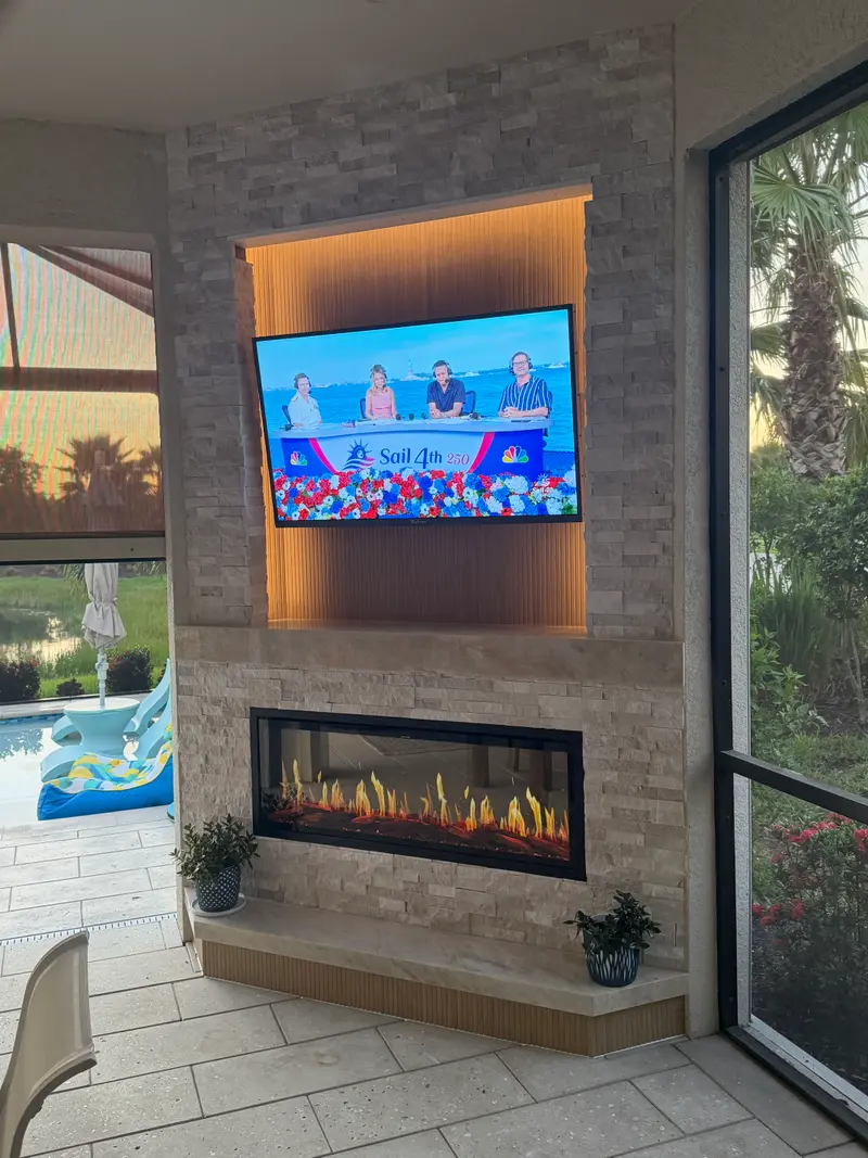 Lanai fireplace wall with a lit niche beside the pool