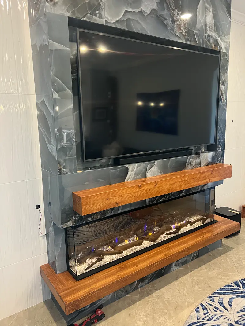 Side view of a blue onyx fireplace wall with a live-edge wood mantel
