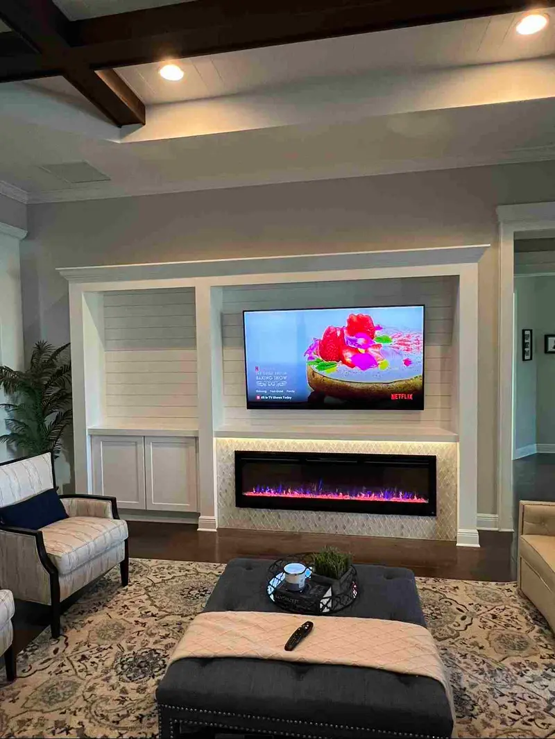 White living room built-in with open shelves and a linear electric fireplace